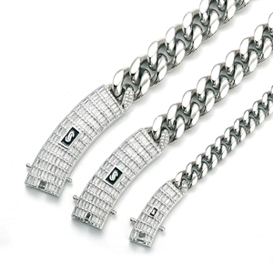 Close-up of three silver polished Cuban link necklaces with micro-pave zircon clasps