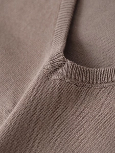 Detailed close-up of V-neck stitching and high-density knit texture in khaki brown color