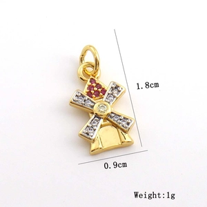 Detail view of 1.8cm x 0.9cm gold windmill charm with white and red zircon inlays