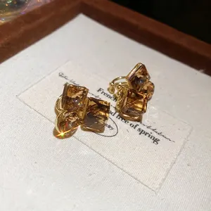 Vintage gold plated square ear cuff with champagne crystals on a luxury velvet gift box