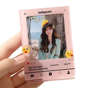 Pink acrylic Instagram style photocard display stand with heart icons and beach photo