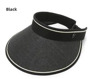 Detail of black straw open top sun hat featuring breathable weave and metal G logo