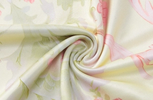 Détail de l'imprimé floral sur tissu jaune lisse avec texture soyeuse et beau drapé