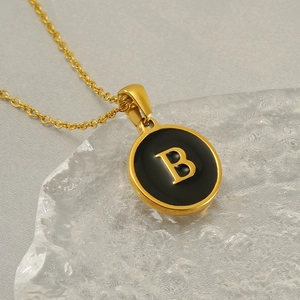 Classic gold stainless steel necklace with round black pendant featuring letter B detail