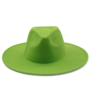 Flat lay of grass green wide brim wool felt jazz fedora hat on white background
