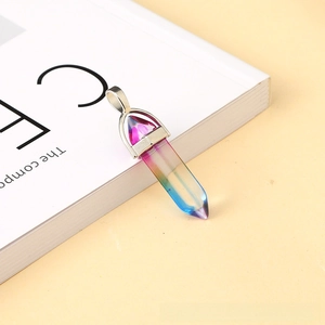 Macro shot of rainbow gradient hexagonal crystal pendant with a silver metallic clasp