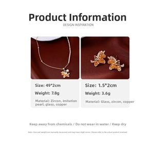 Detailed view of zircon pearl horse pendant necklace and earrings on red velvet background