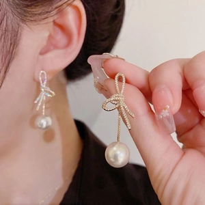 Bowknot pearl drop earrings with sparkling zircon inlay in elegant gold finish