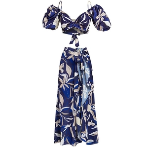 Flat lay of navy floral off-shoulder bikini top and high waist wrap skirt set