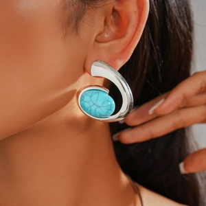 Detailed side view of a silver irregular geometric earring with oval blue turquoise stone