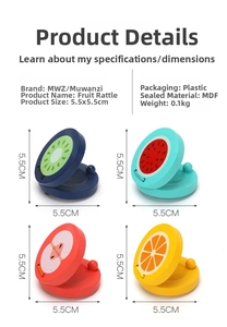 Detail of wooden fruit castanets showing kiwi, watermelon, apple, and orange designs