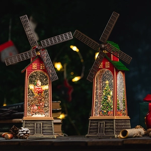 Christmas lantern music box with Santa and tree scenes in warm festive holiday setting