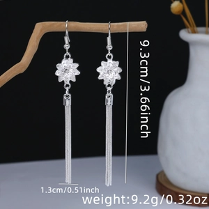 Detail view of ethnic floral silver tassel earrings with 9.3cm length specification