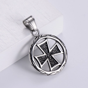 Silver vintage stainless steel Maltese cross pendant on a white wooden display block
