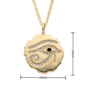 Detailed macro view of 20mm golden Eye of Horus pendant with zircon and black stone