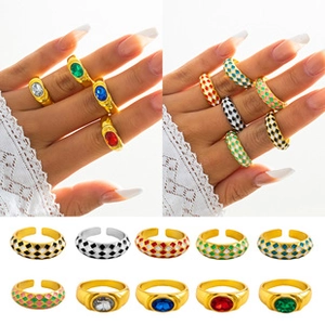Selection of wide gold rings with colorful oval gemstones and geometric enamel patterns