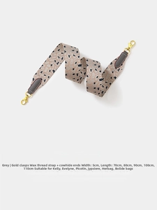 Close-up of 5cm wide gray leopard woven shoulder strap with gold buckle and cowhide ends