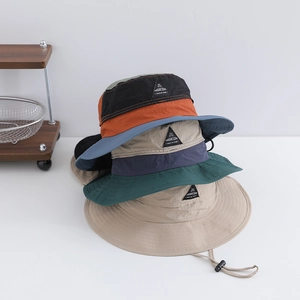 Close-up of three color-block outdoor sun hats with adjustable drawstrings and side tags