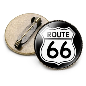 Close-up of vintage Route 66 round shield brooch with crystal glass dome and bronze base