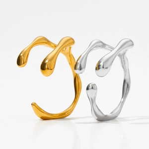 Modern gold and silver irregular liquid lava style stainless steel rings in a split view