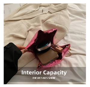 Internal storage view of the star-shaped pink acrylic bag holding phone and lipstick