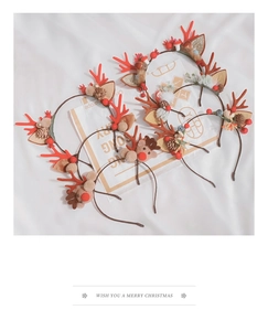 Detailed flat lay of 6 Christmas antler headbands with plush deer and berry accents