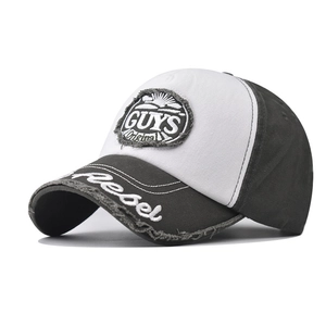 Detail of cotton baseball cap with GUYS embroidery and contrast grey and white panels