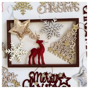 Flat lay of velvet burgundy Christmas tree ornaments with sequins and wooden stars