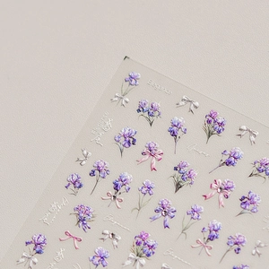 Elegant purple iris flower nail stickers with 3D bows and diamond finish on gray background