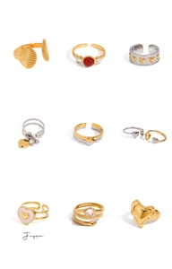Detailed view of nine 18K gold-plated titanium rings with zircon and heart motifs