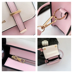 Detail view of pink and white color-block handbag with gold hardware and logo engraving