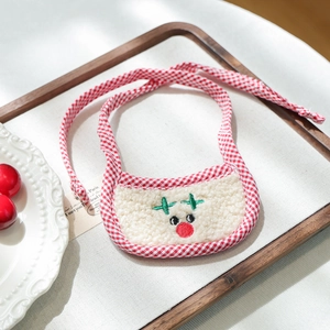 Detail of Christmas reindeer embroidery on cream fleece bib with red checkered ties