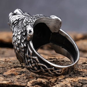 Detailed macro view of the vintage viking wolf head ring with intricate textures on wood