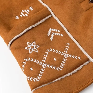 Detail of brown faux suede jacket with white floral embroidery and faux shearling lining