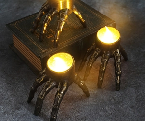 Detailed view of skeleton hand LED candle holders with vintage bronze finish for Halloween