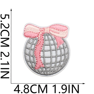 Detail showing dimensions of a grey disco ball embroidery patch with a pink bow
