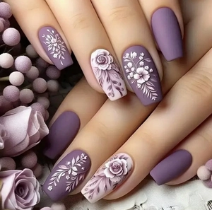 Detail of matte lilac press-on nails with 3D embossed floral patterns and elegant finish