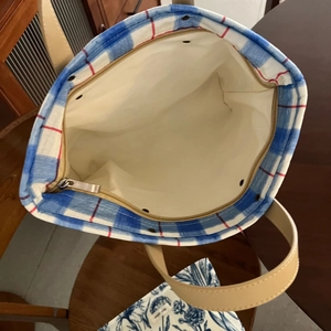 Top view detail of plaid tote bag interior with zipper closure and spacious lining