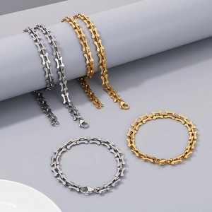 Detailed view of bone-shaped link chain necklaces and bracelets in gold and silver finish