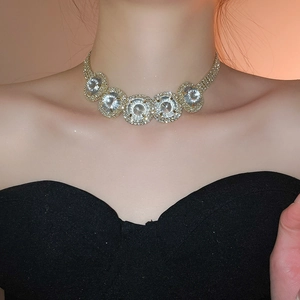 Detailed close-up of a luxury gold-plated necklace with sparkling round crystals