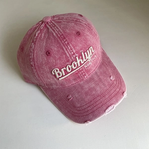 Macro detail of Brooklyn New York 3D embroidery on pink washed denim baseball cap