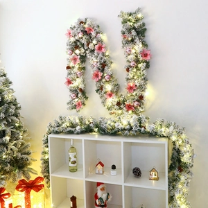 Snow-flocked 2.7m Christmas garland with pink flowers, pine cones and warm LED lights