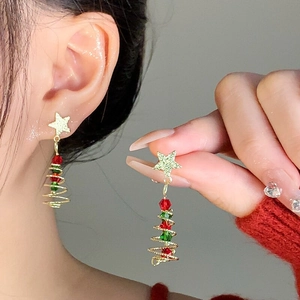 Detailed close-up of Christmas tree drop earrings with colorful beads and gold stars