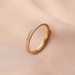 Detailed macro view of an elegant rose gold eternity ring with sparkling crystals
