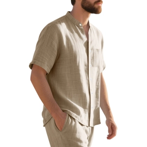 Detail of men's linen short sleeve shirt showing mandarin collar and chest pocket texture