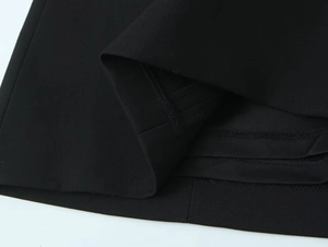 Gros plan détaillé de l'ourlet à double couture et de la texture d'une robe noire d'été