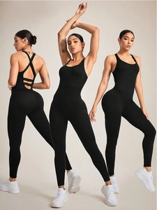 Detail of black seamless yoga jumpsuit with crisscross back and ribbed texture fabric