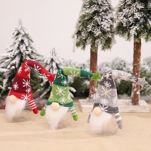 Three Christmas gnome candy jars in red, green and grey with knit hats and clear bases