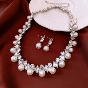 French vintage necklace and earring set with pearls and diamonds on red velvet