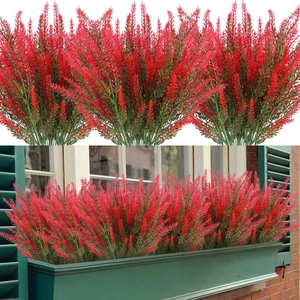 Outdoor window decor featuring red artificial lavender plants in green flower box